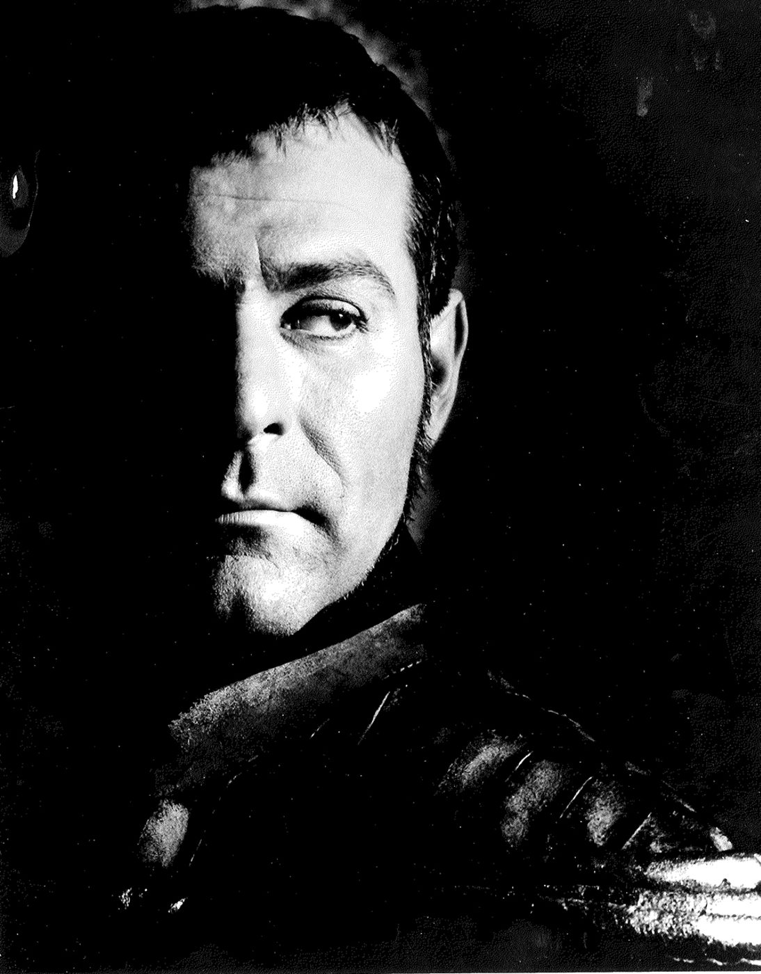 Sam Wanamaker Iago Royal Shakespeare Theatre A man stands in the shadows